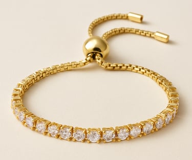 Gold adjustable bracelet with clear gemstones on a light background