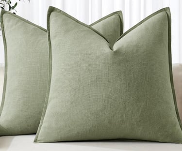Pair of sage green linen decorative throw pillows with flanged edges.