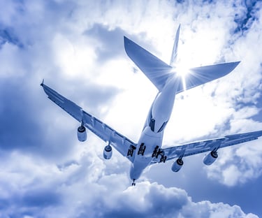 Airplane flying through clouds with sunlight capturing the feeling of Disney adventure