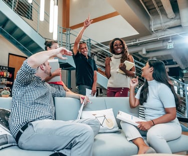 a group of young professionals smiling in celebration