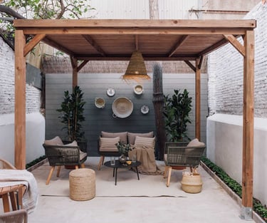 Outdoor terrace with seating and green plants, offering a serene atmosphere in Barcelona apartment