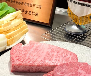 a table with a plate of raw wagyu meat