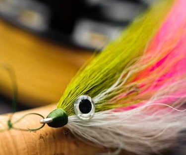 a fly fishing lure with a green and white fly