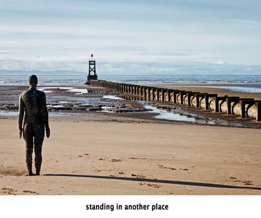 antony gormley's iron man standing in another place