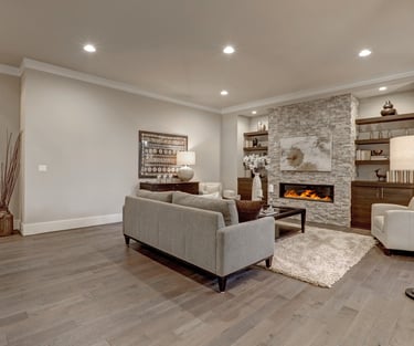 Newly finished basement with luxury vinyl flooring, recessed lighting and electric heat fireplace