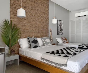 a bedroom with two beds and a television