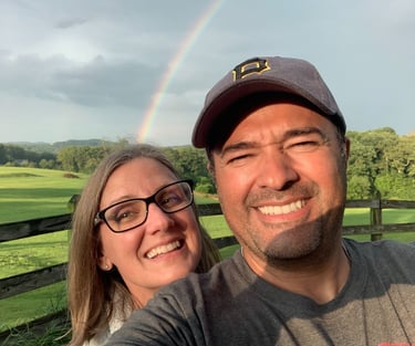 husband and wife taking a selfie on our lavender farm with rainbow - colored rainbows