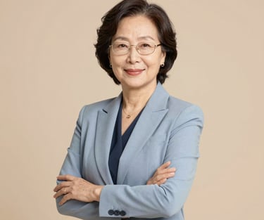 A smiling woman sitting at her laptop, engaged in an online English lesson.