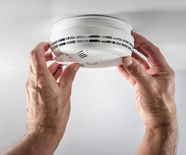 Suasana Security installing fire alarm and smoke detector systems for safety.