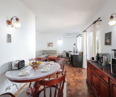 The photo shows an open-plan dining and living room.