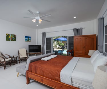King size bed in Poolside Studio with sliding glass doors to the patio