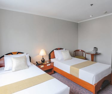 a bedroom with two twin beds and a table