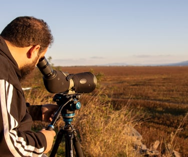 a man in a black jacket and a camera on a tripod
