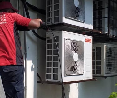 Suasana Aircond cleaning multiple outdoor condenser units for maintenance service.