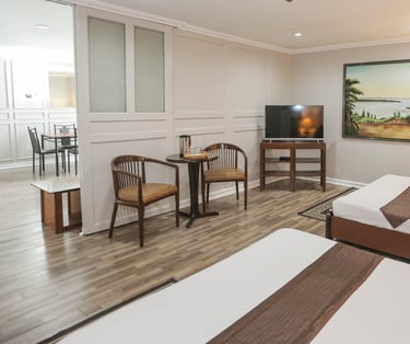 a hotel room with two beds and a television