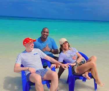 Couple enjoying a romantic day at Nakupenda Beach Sandbank, Zanzibar, with a friendly local tour guide by the clear blue wate