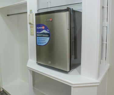 a mini fridge and cabinets