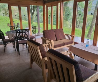 Seating area of a mountain homestay in Chikmagalur with a scenic view