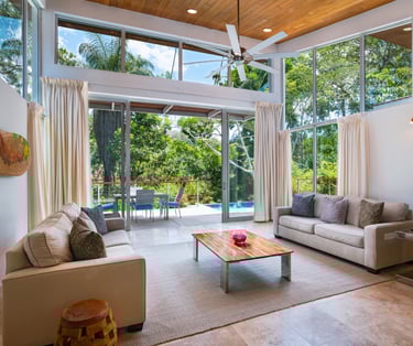 a living room with a couch and a table in this amazing Belize Villa
