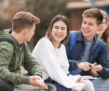 a group of young people sitting on a bench