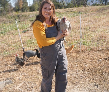 owner holding chicken 