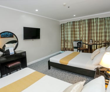 a hotel room with two beds and a television