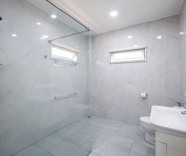 Spacious marble-style bathroom with a large walk-in shower.