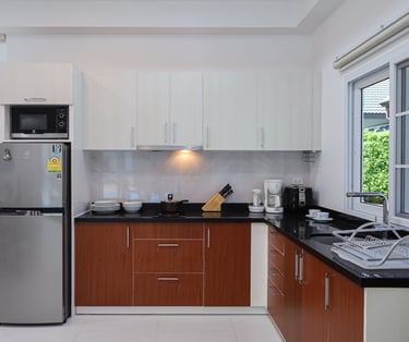 Full-size kitchen with a window, large fridge, and coffee maker.