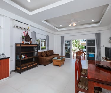 Spacious living room interior with dining area in One Bedroom Suite