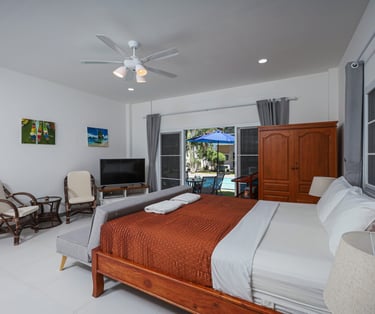 King size bed in Poolside Studio with sliding glass doors to the patio
