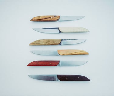 minimalistic table knives on a white surface