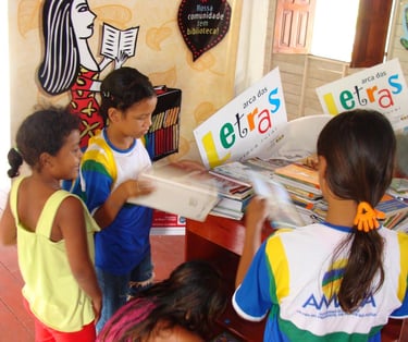 Children engaged in reading activities at the Arca das Letras rural community library in Brazil, hig