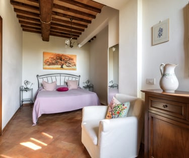 a bedroom with a bed and a chair