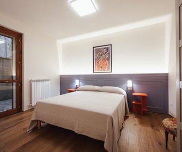 a bedroom with a bed and a small table