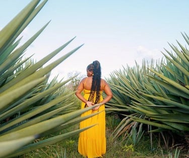 a woman in a yellow dress standing in a field
