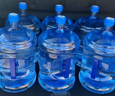 Six 18.9L spring water jugs for Aquifer Springs refills.