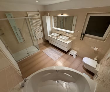 a bathroom with a tub tub and a large mirror