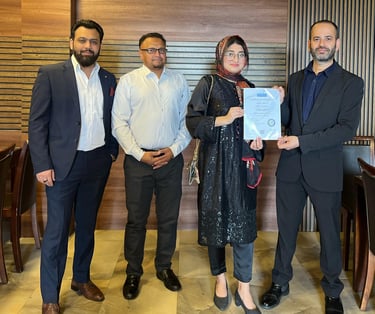 SESI Officials presenting a certificate of achievement to a female Personal trainer.