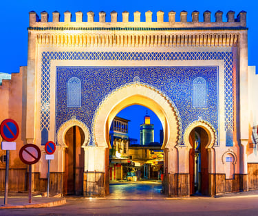 a building with a large archway and a blue sky