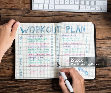 a woman's hand holding a pen and writing on a notebook