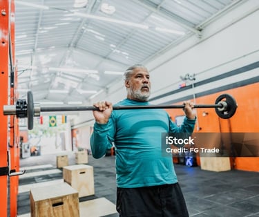 a man in a blue shirt is holding a barbell
