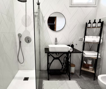 Modern bathroom with walk-in shower and elegant black fixtures in Sicily villa