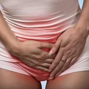 фото жінка тримається за болючий живіт