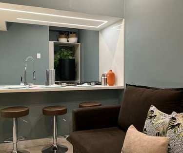 a living room with a couch and a bar stool