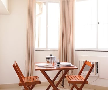 a table with chairs and a table with a cup of coffee