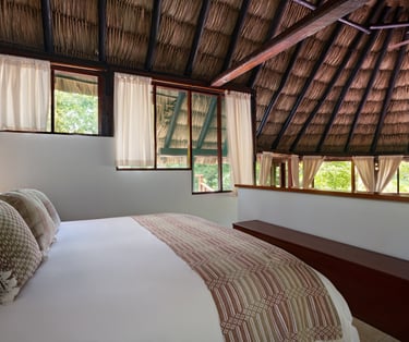 thatched roof and large bed 