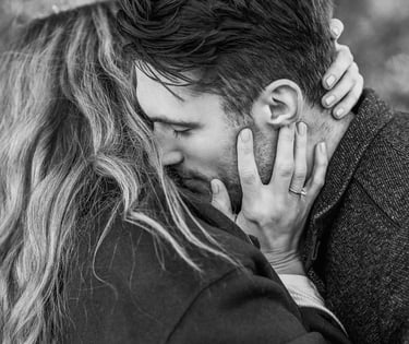 a man and woman kissing in black and white