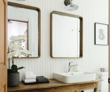 a bathroom with a sink and a wooden table