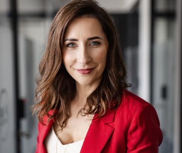 a woman in a red jacket and white top