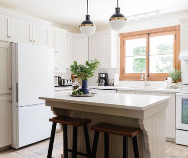 a kitchen with a large island and a white refrigerator